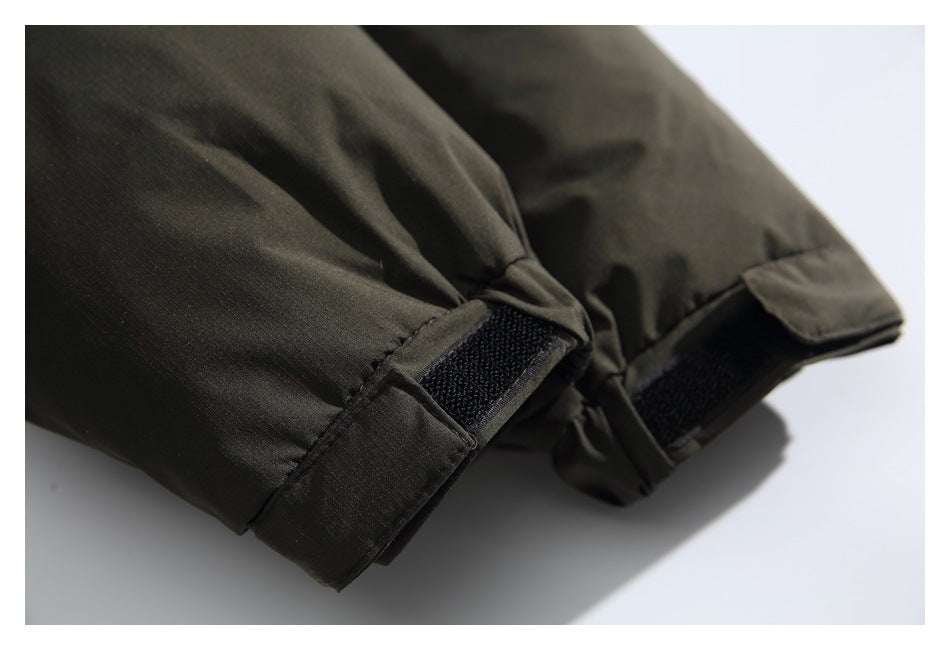 Close-up of the jacket's olive sleeve cuffs with adjustable hook-and-loop tabs.