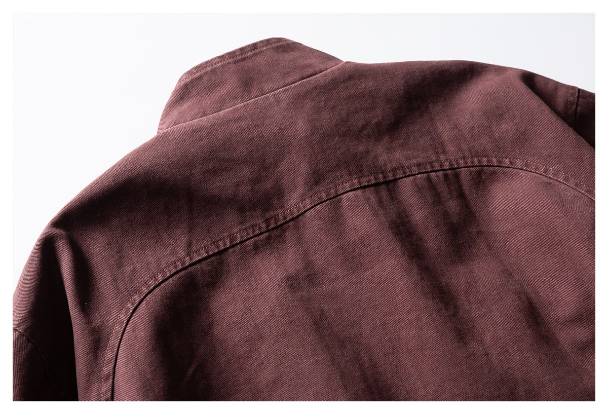 Close-up of the burgundy garment's back shoulder area, showing a curved yoke seam.