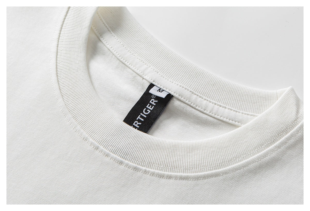 Close-up of a white T-shirt crew neckline with ribbed trim and a black woven neck label.