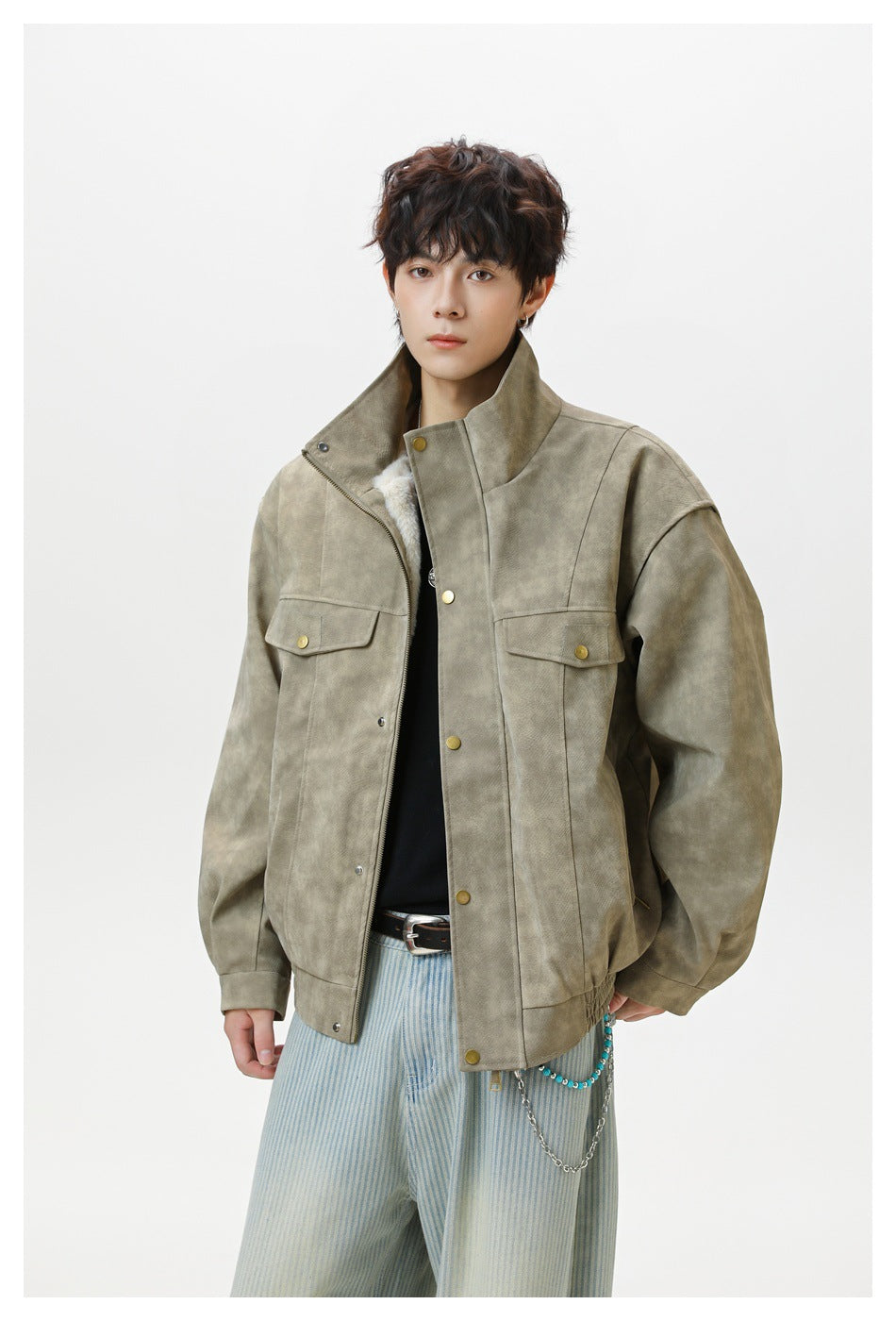 Front view of a model wearing an olive-gray jacket with a high collar, snap closure, and two flap chest pockets.