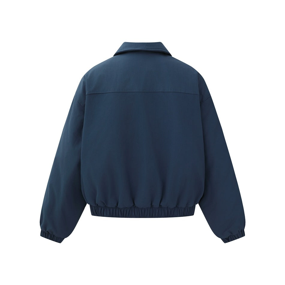 Back view of a dark navy jacket laid flat, with a back yoke, long sleeves, and gathered cuffs and hem.