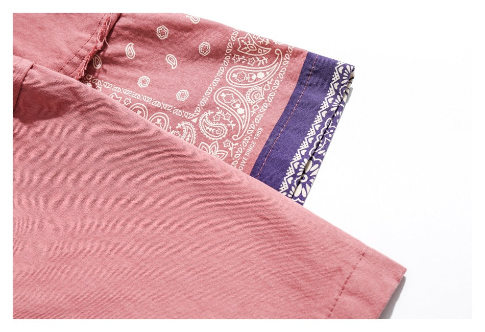 Close-up of the dusty rose shirt sleeve and cuff, with a contrasting purple and pink paisley-print panel.