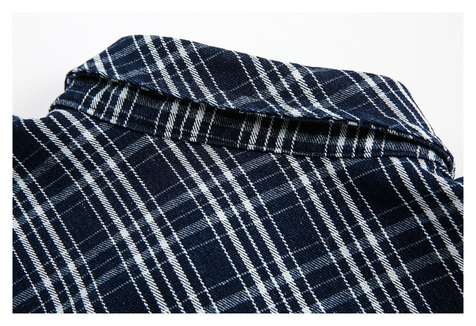 Close-up of a navy and white plaid garment collar and fabric.