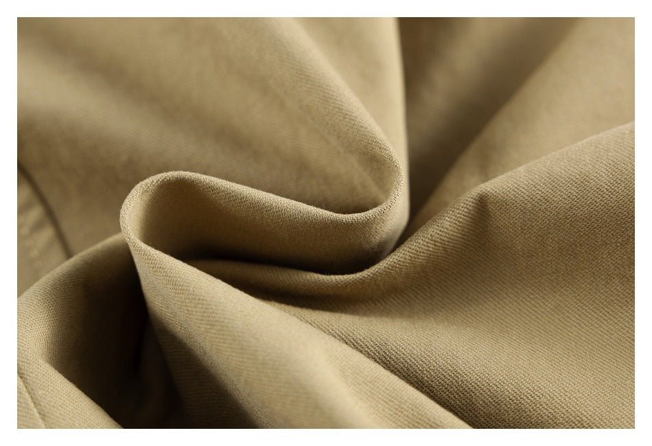 Close-up showing the texture and soft folds of beige garment fabric.