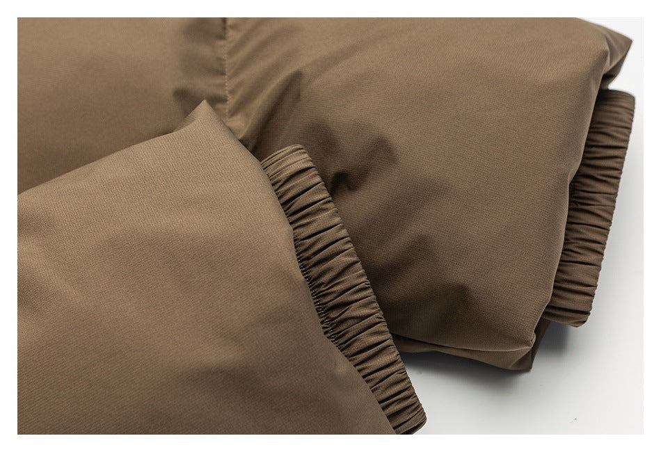 Close-up of brown garment sections with gathered elastic cuffs or hems.
