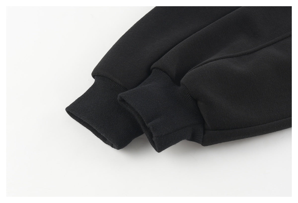 Close-up of black sleeves with ribbed cuffs and a stitched hem.
