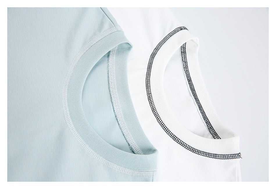 Close-up of pale blue and white T-shirt necklines showing ribbed collars and stitching.