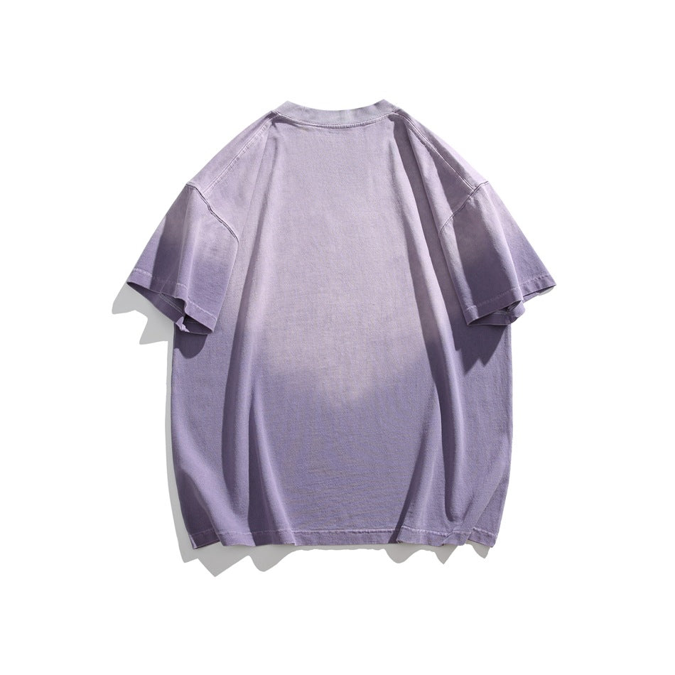 Back view of a plain oversized lavender short-sleeve T-shirt laid flat on white.