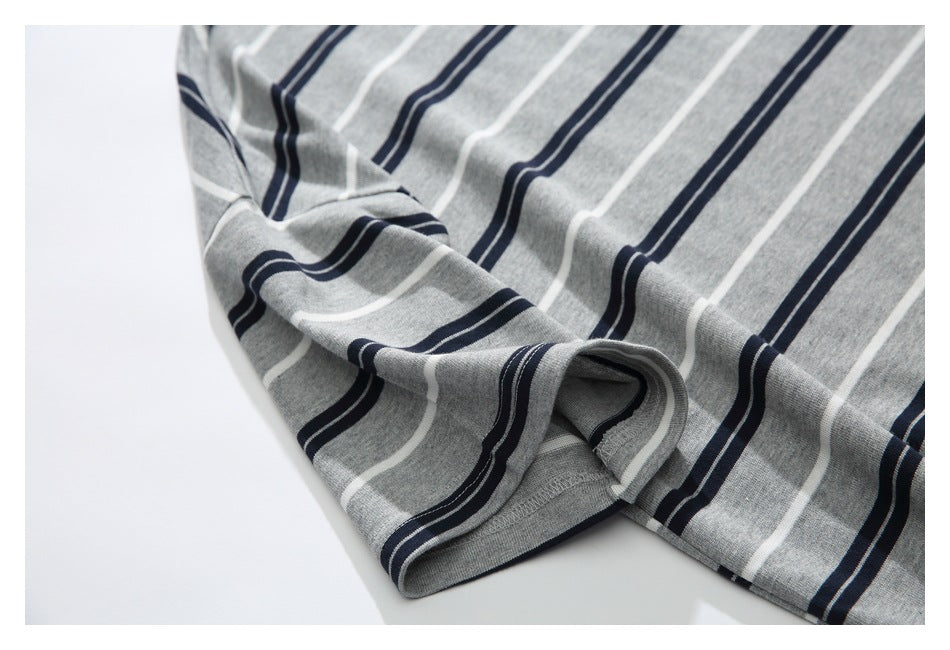 Close-up of the gray T-shirt's striped short sleeve and finished cuff.