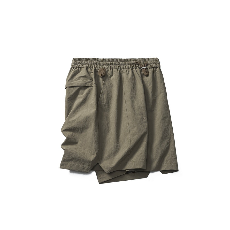 Olive-gray shorts laid flat, with a gathered drawstring waist, layered front panels, and a flap pocket.