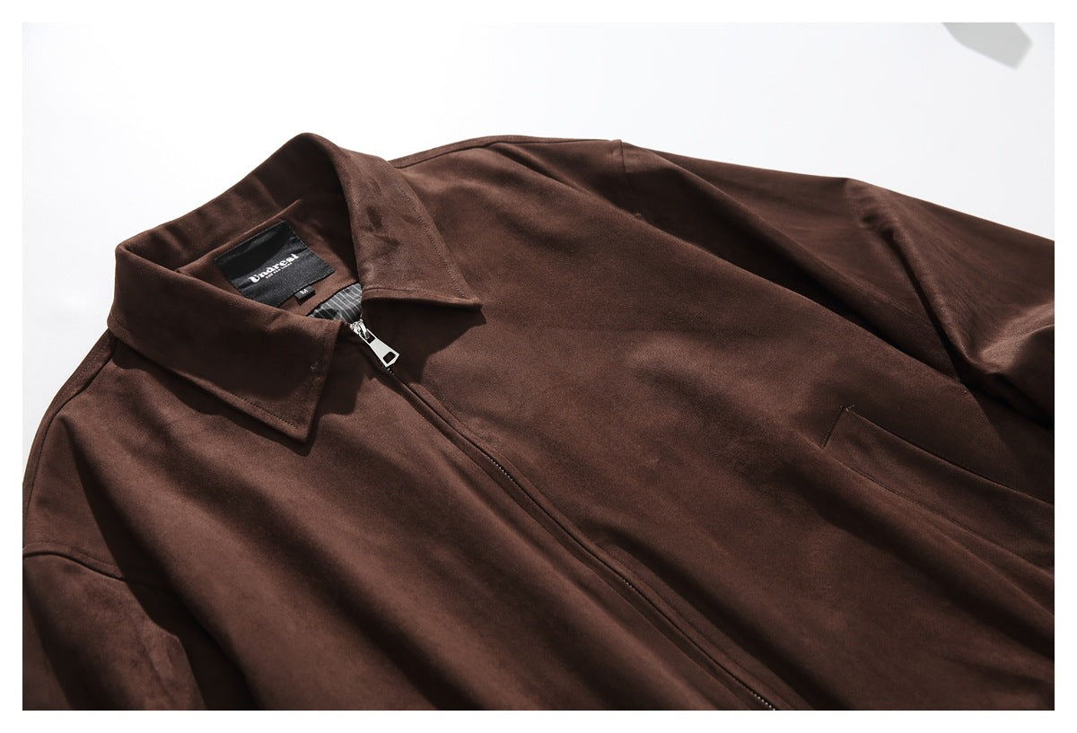 Close view of the dark brown jacket's pointed collar, zipper and upper front, laid flat.