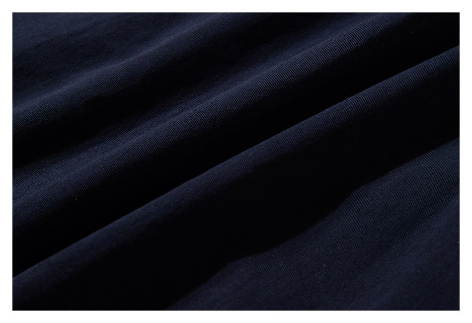 Close-up of dark navy fabric arranged in soft folds.