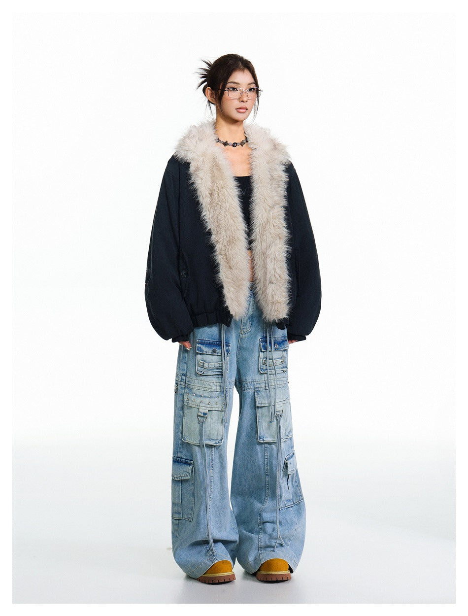 Model wearing an open black jacket with a long, plush light-beige fur collar and trim, paired with wide-leg cargo jeans.