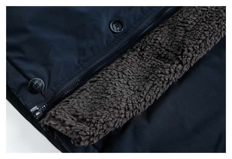 Close-up of a dark navy jacket with a brown textured lining, zipper, and buttons.