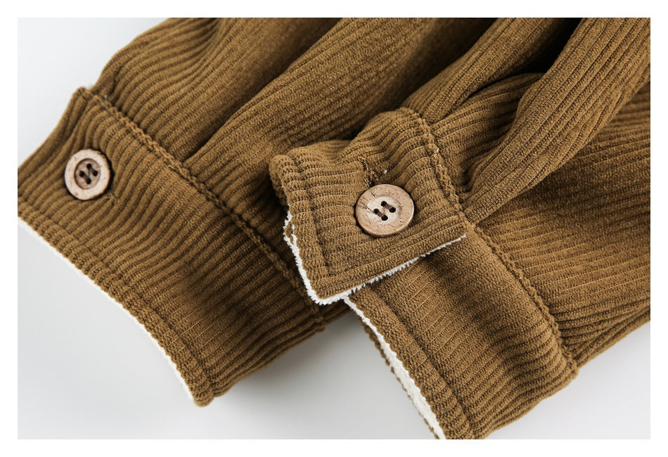 Close-up of a brown ribbed jacket cuff with a light brown four-hole button and white lining visible at the edge.