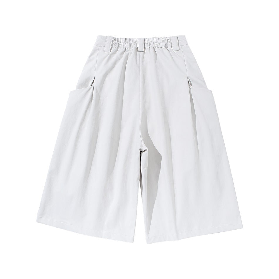 Front flat lay of white wide-leg shorts with pleats, an elasticated waistband, belt loops and large side pockets.