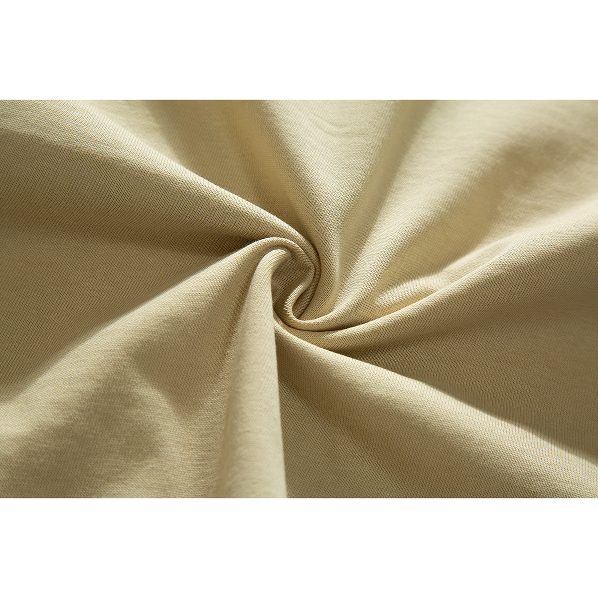 Close-up of beige fabric gathered into a twist, showing its fine surface texture.