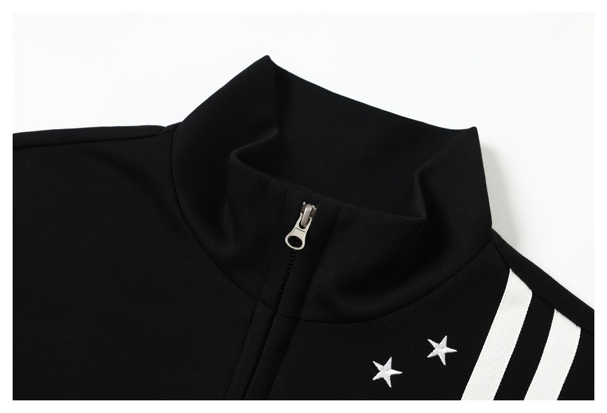 Close-up of a black garment's stand collar, front zipper, white stars, and stripes.