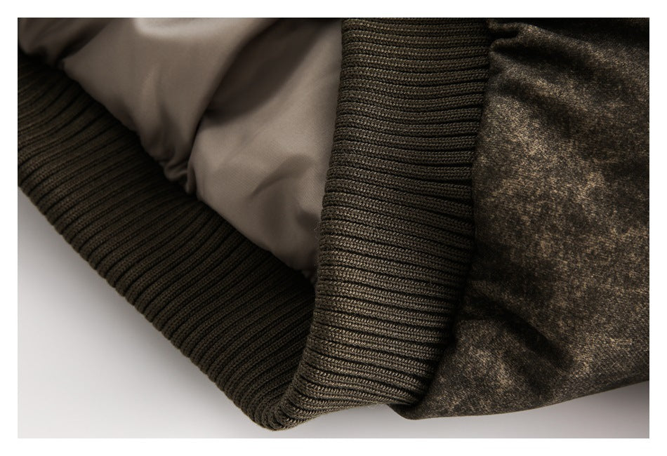 Close-up showing the jacket's beige lining, dark rib-knit trim, and mottled brown outer fabric.