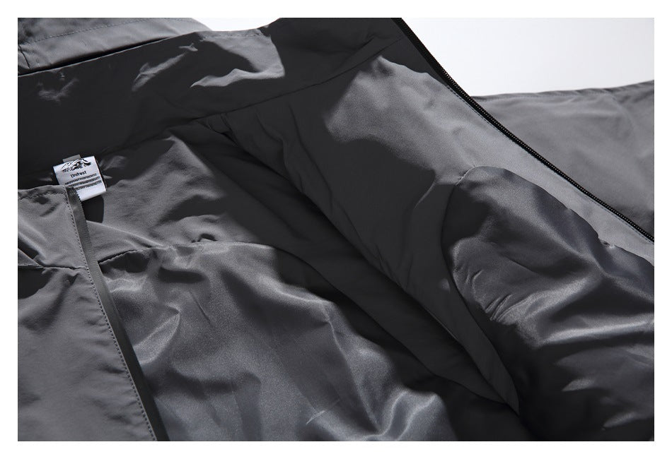 Open charcoal jacket showing its interior lining, sleeve, zipper, and sewn-in label.