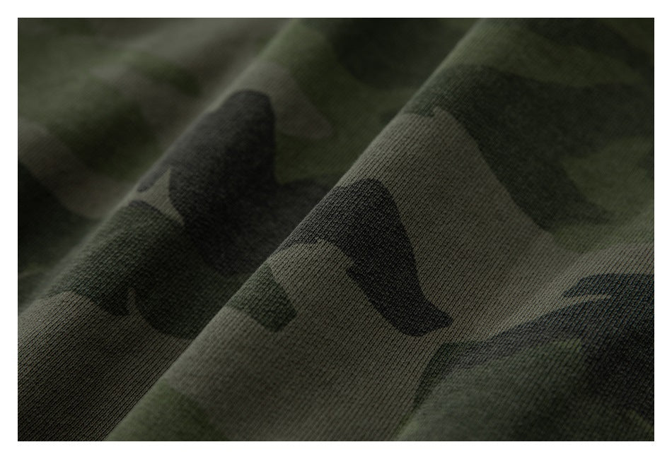 Close-up showing the dark green and black camouflage pattern on the garment fabric.