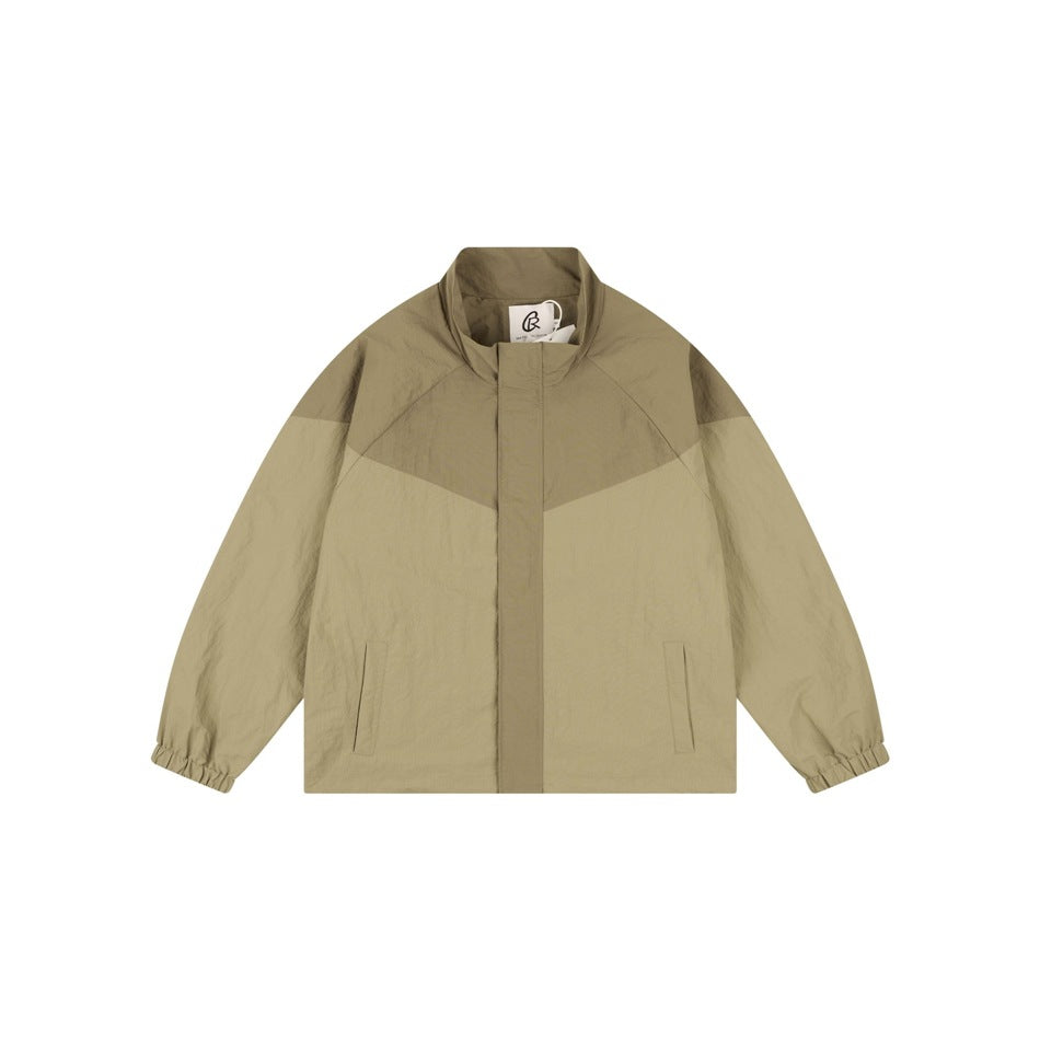 Khaki color-block stand-collar jacket flat lay, front view, with chevron panel and elastic cuffs