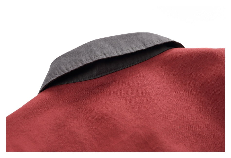 Close-up of the brick-red jacket's back neckline with a contrasting dark gray collar.