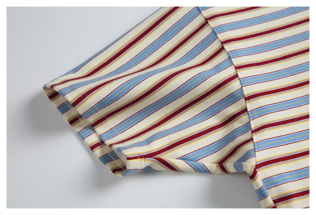 Close-up of the striped T-shirt's short sleeve and underarm seam on a light background.