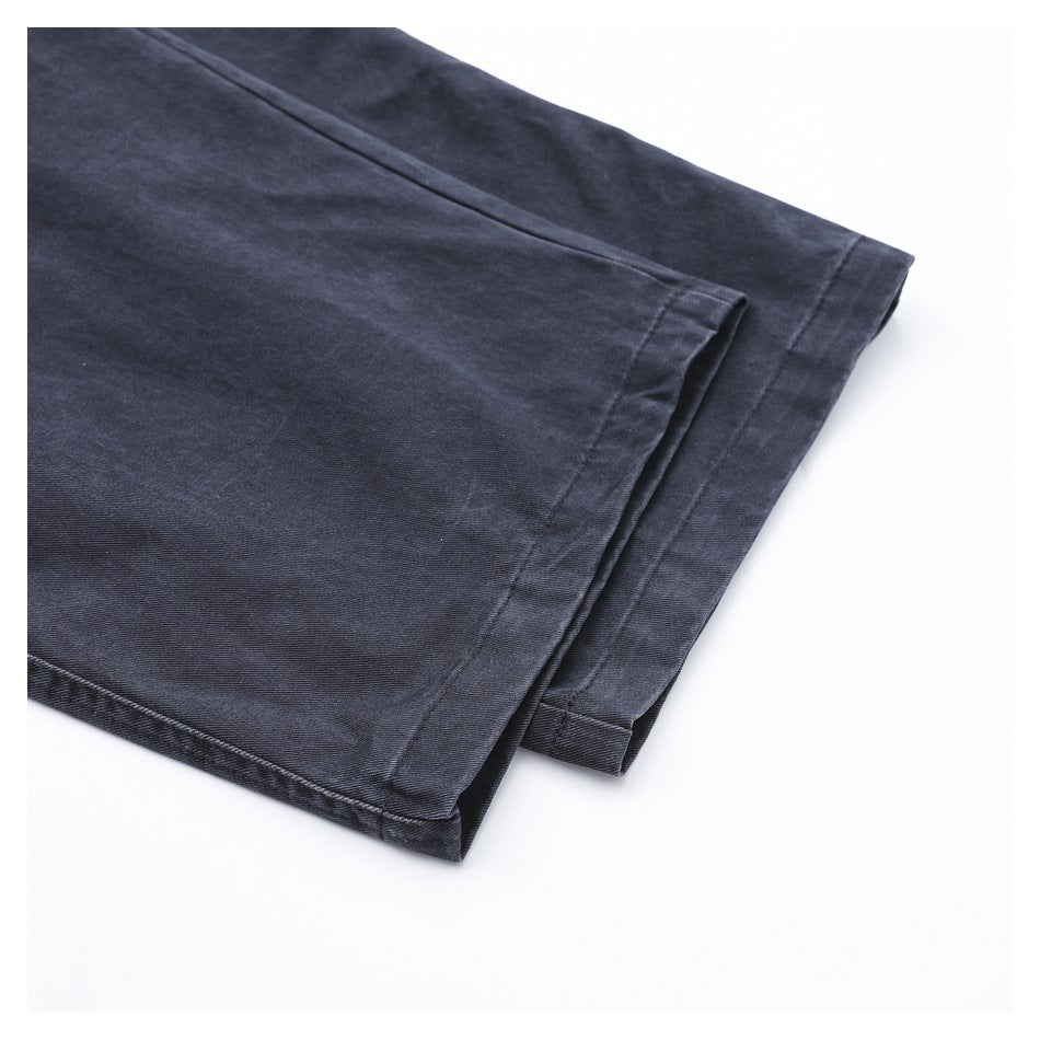 Close-up of charcoal trouser legs showing the stitched hems and fabric finish.