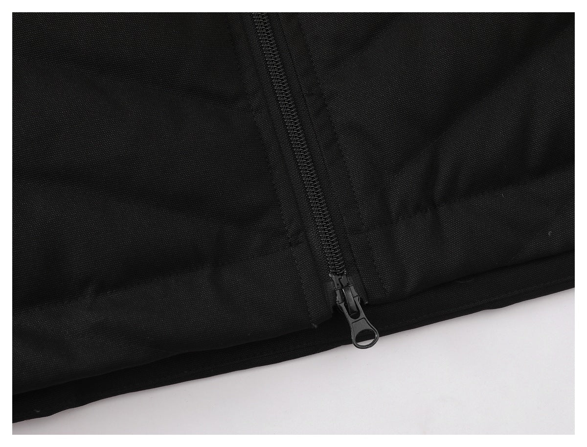 Close-up of the black jacket's zipper end and lower hem.