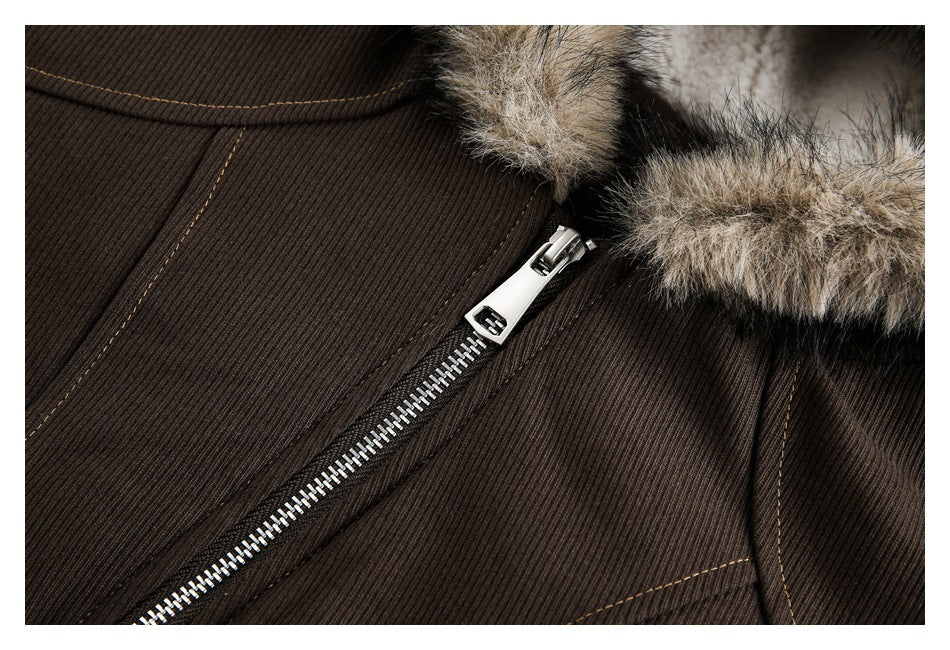 Close-up of a brown ribbed jacket front with a silver zipper, fur-trimmed edge, and tan contrast stitching.