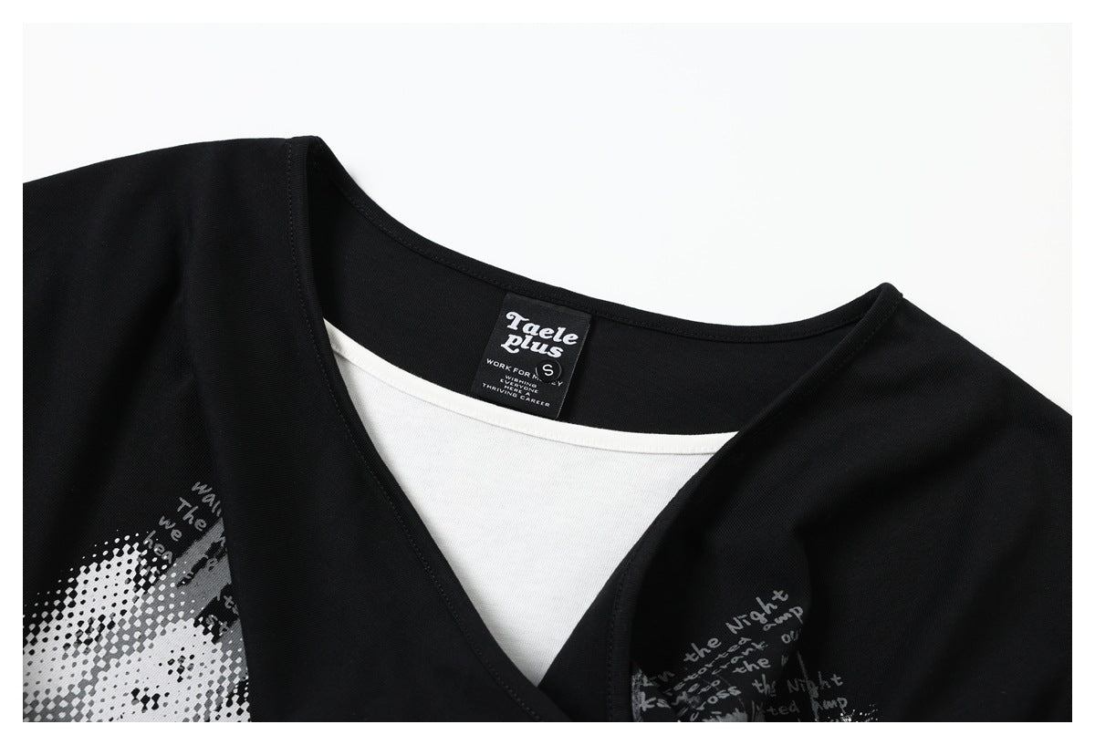 Close-up of a black wrap neckline with a white inner layer and sewn neck label.
