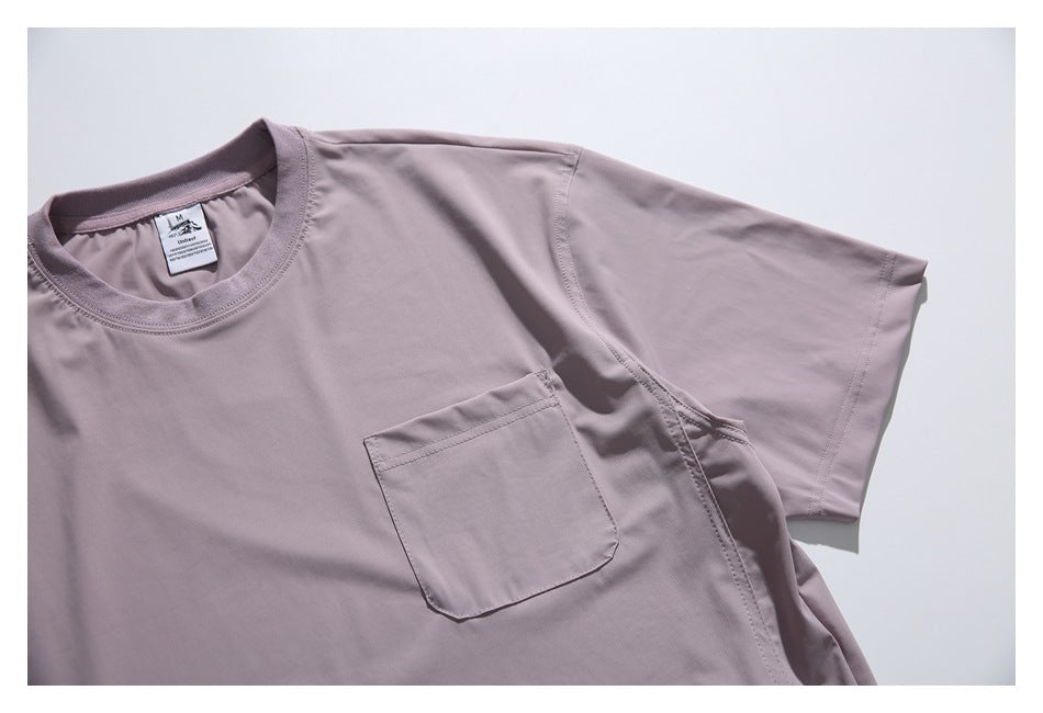 Close view of a dusty mauve short-sleeve shirt showing its crew neck and single chest pocket.