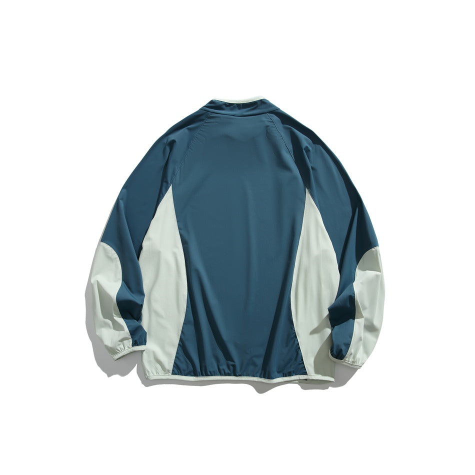 Back view of a teal pullover with pale side panels, pale sleeve sections, and a pale-trimmed hem.
