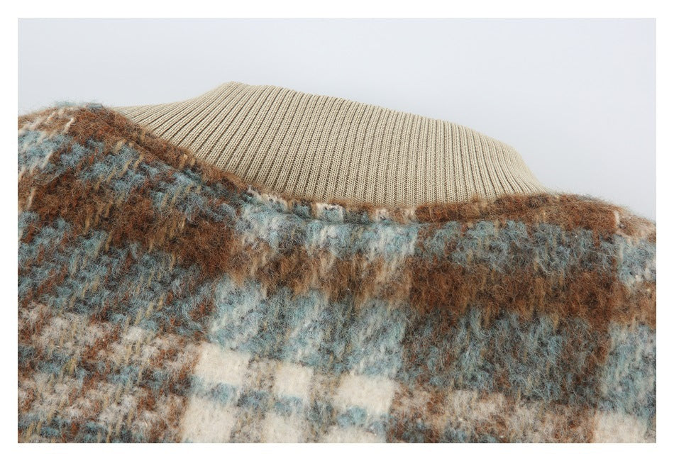 Close-up of a beige ribbed collar against fuzzy brown, blue-gray, and cream plaid fabric.