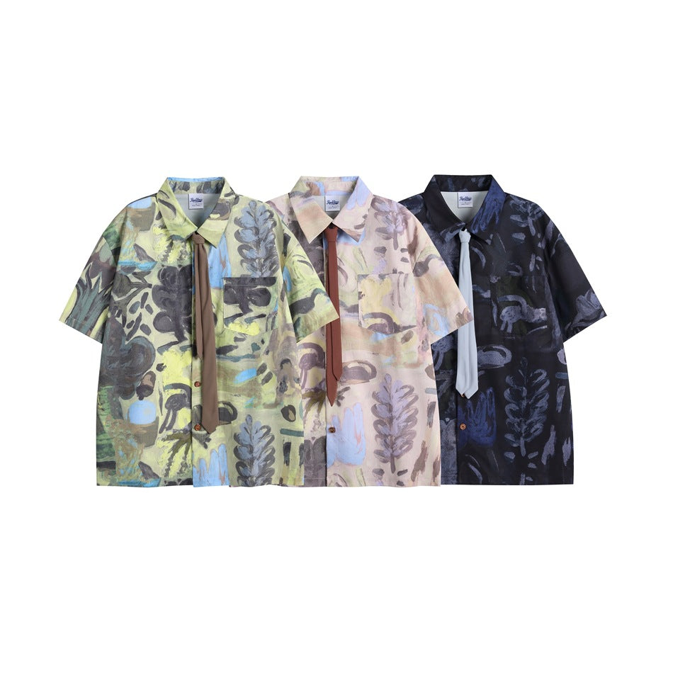 Three short-sleeve abstract-print button-up shirts shown together in green, pastel pink and dark navy colorways.