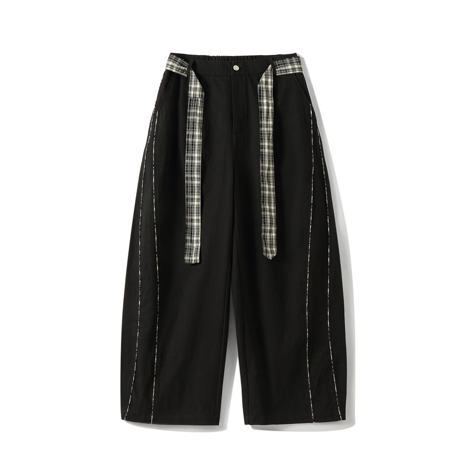 Black wide-leg pants with plaid tie belt and plaid piping along curved side seams, front view