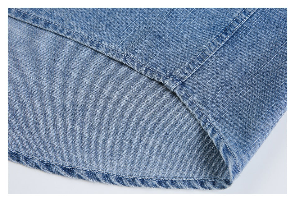 Close-up of a stitched hem and seam on blue denim.
