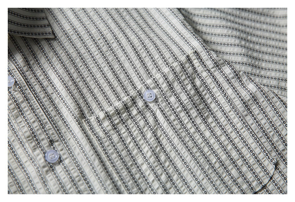 Close-up of the shirt's striped chest pocket and white buttons.