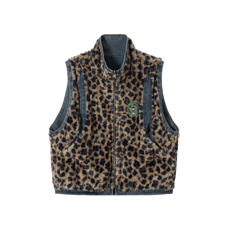 Front view of a sleeveless tan and navy leopard-pattern vest with denim trim, a raised collar, zipper, and chest patch.