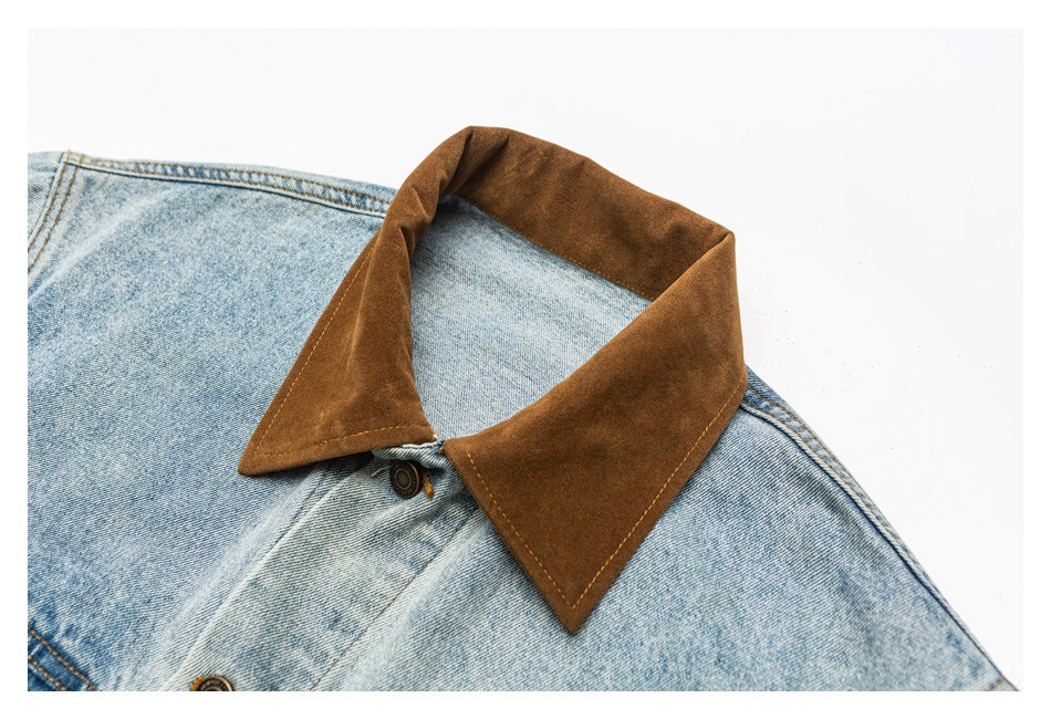 Close-up of the jacket's brown pointed collar and upper light blue denim with a metal button.