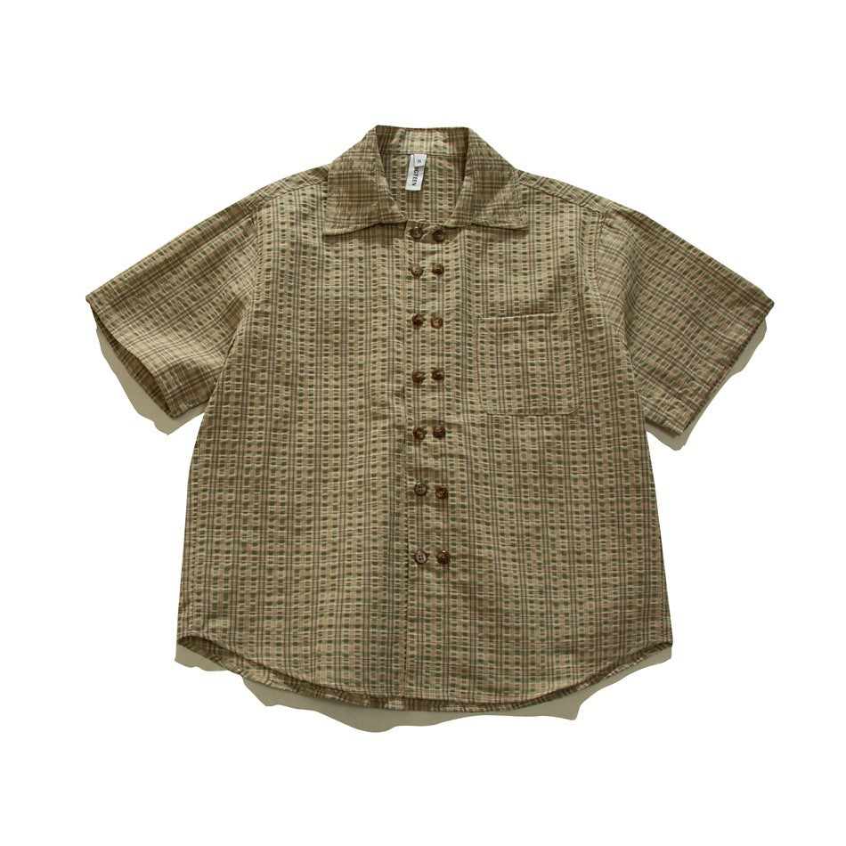 Olive green and tan plaid short-sleeve shirt with double row of brown buttons and chest pocket, flat lay front view