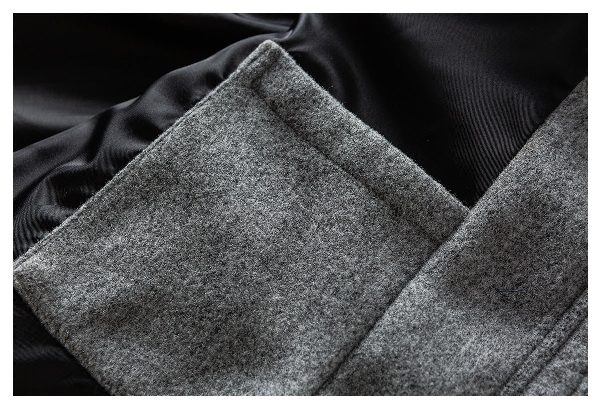 Close-up of gray fabric construction and a seam against smooth black lining.