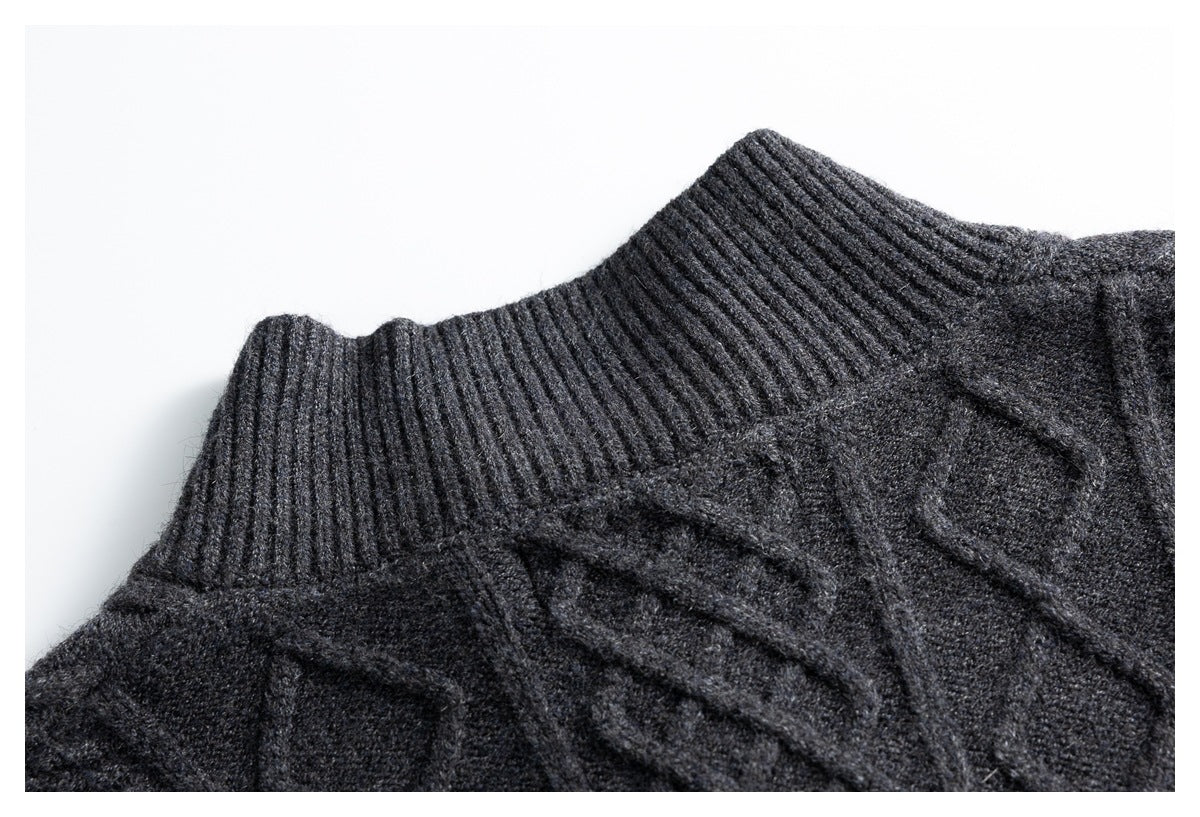 Close-up of a charcoal sweater's ribbed high neckline and raised cable-knit pattern.