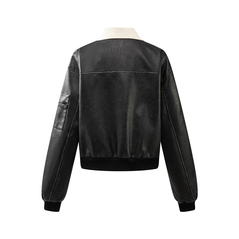 Back view of black cropped faux-leather jacket with cream collar, yoke seam, sleeve pocket and ribbed hem