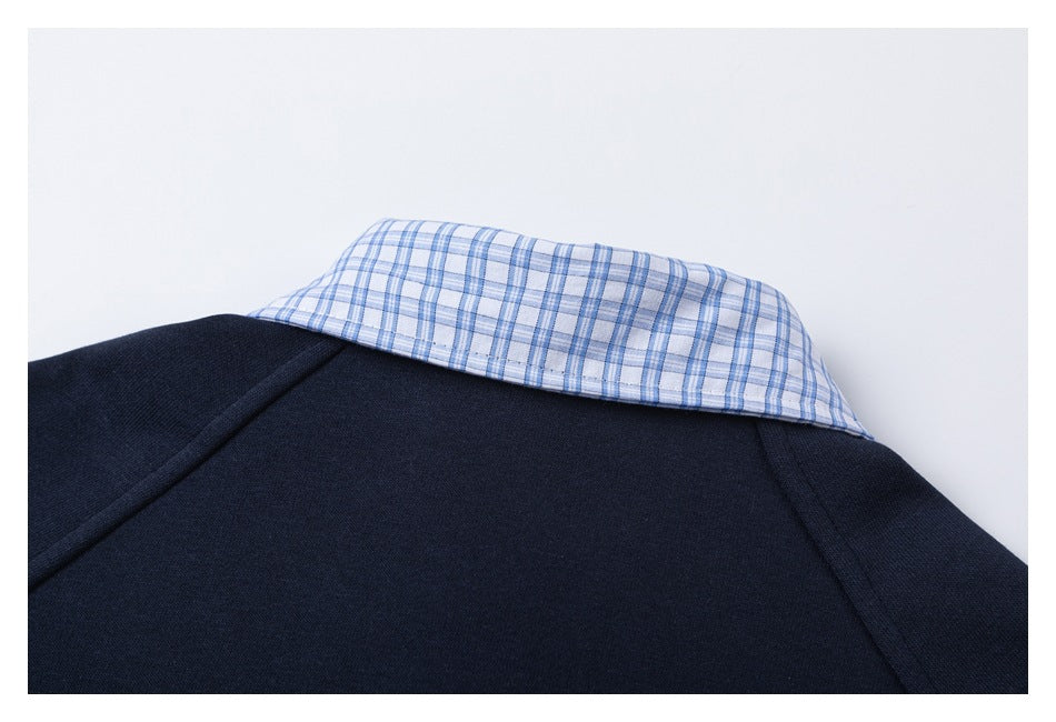 Back neckline detail of a navy sweatshirt with a blue-and-white plaid shirt collar.
