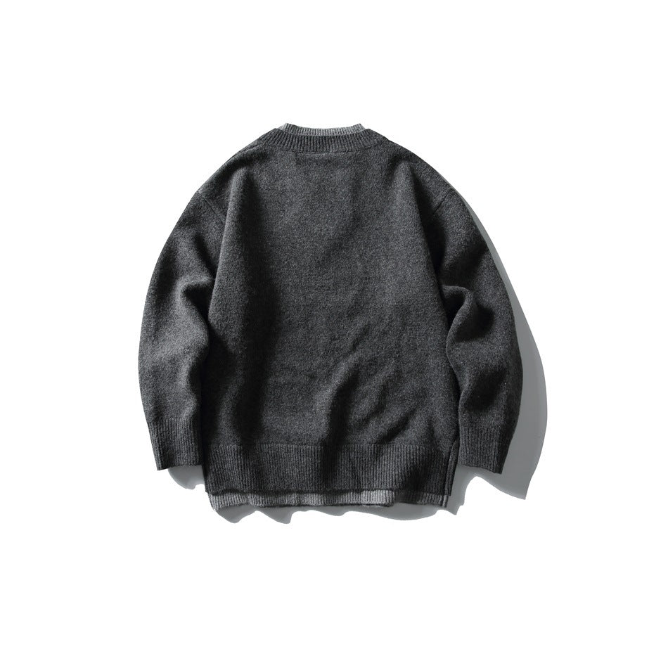 Back view of a charcoal knit sweater with long sleeves and ribbed collar, cuffs, and hem.