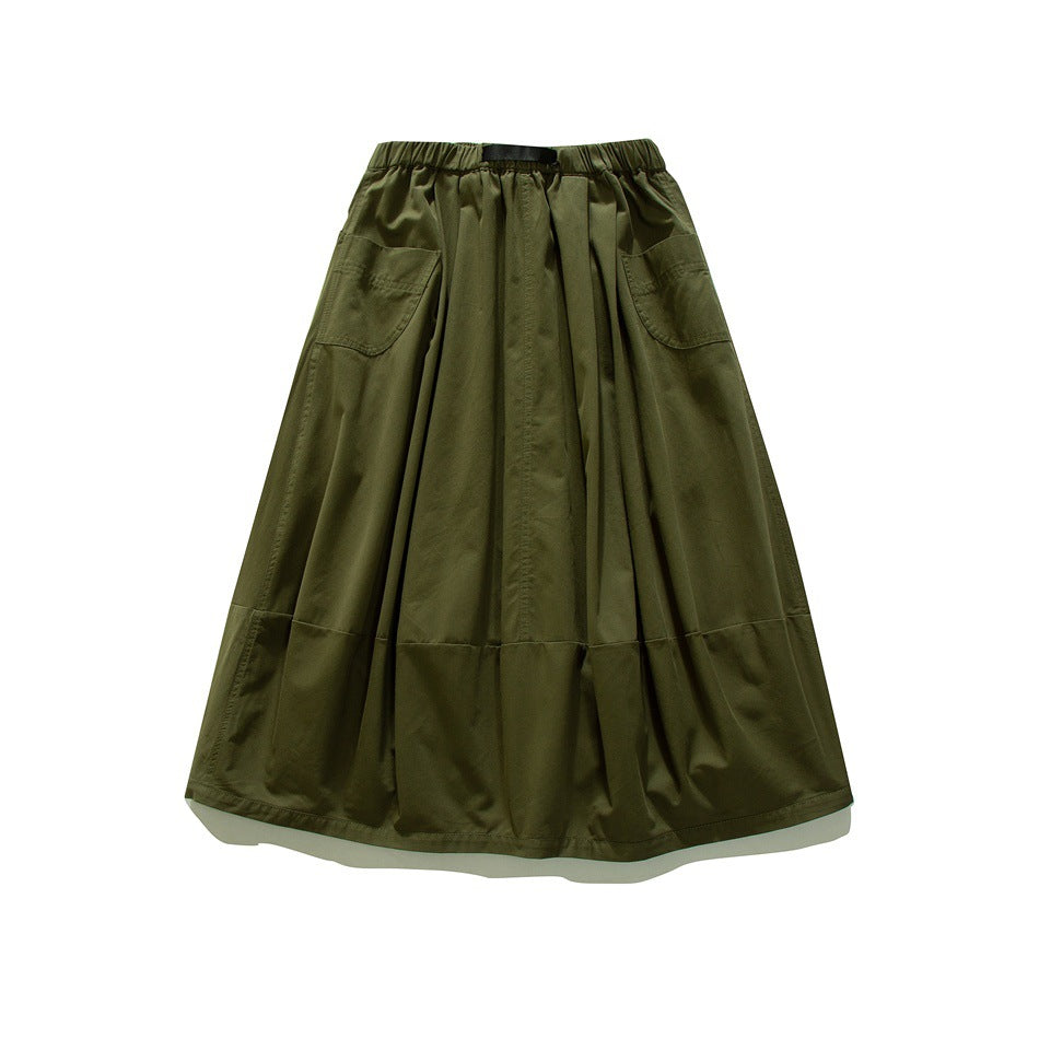 Olive green A-line midi skirt with elastic waist, two large patch pockets and paneled hem, flat lay
