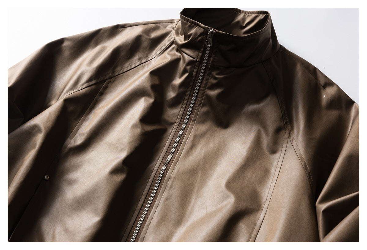 Close-up of a brown jacket's stand collar, front zipper and angled seam detailing.