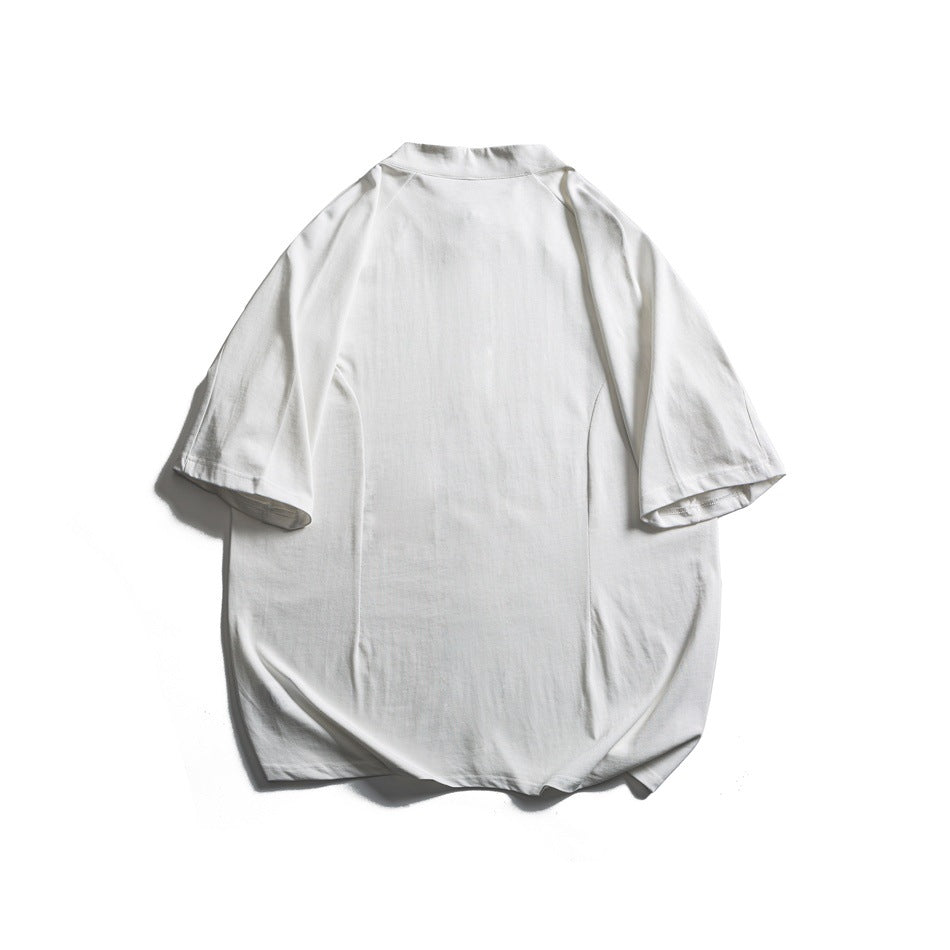 Back view of a white short-sleeve top with a stand collar and curved hem, laid flat.